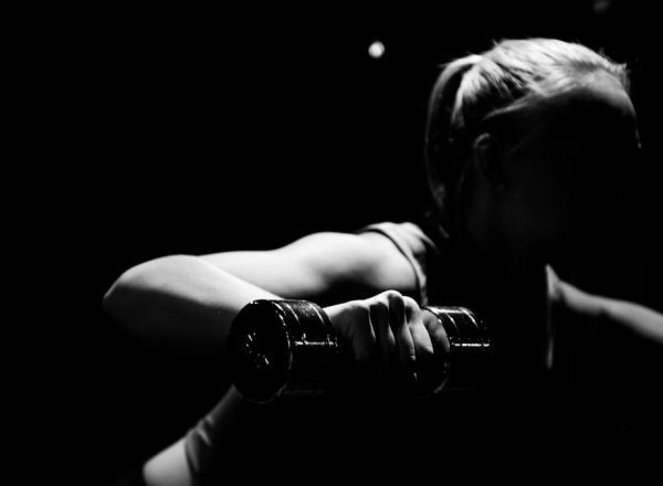woman holding dumbbell